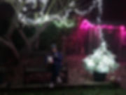 Picture of Victoria and Ralf sitting under the Christmas lights in the garden.