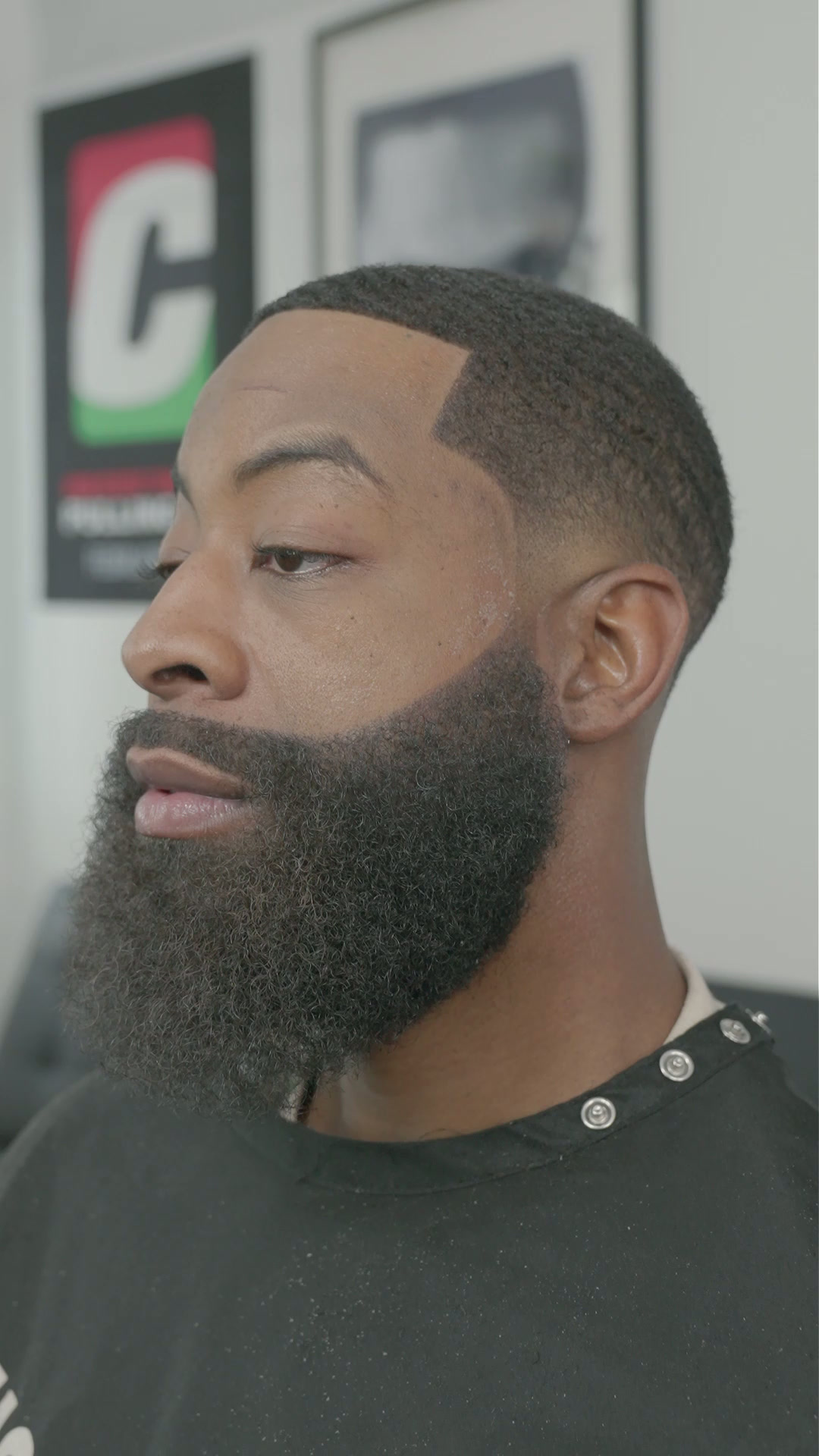 Full beard shaped with a clean tapered haircut on a client