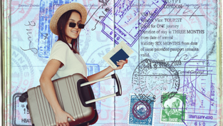 Woman in sunglasses and hat holding a suitcase and passport against a backdrop of colorful passport stamps, smiling cheerfully.