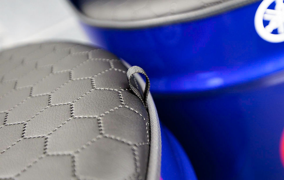 Oil drum seats next to each other showing the leather seating pad.