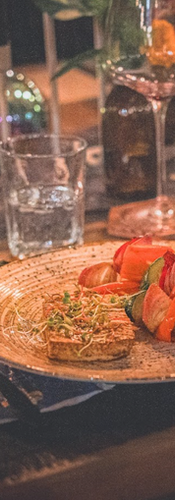 A thoughtfully plated course served during the Halloween dinner, surrounded by candlelight, seasonal floral arrangements and an intimate tablescape.