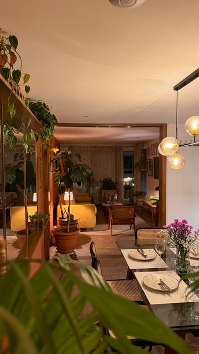 Dinning room filled with plants inside The Greenhouse Residence
