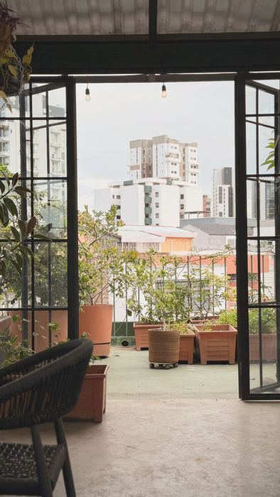 Outdoor terrace lounge at Botanical Rooftop with views over Guatemala City.