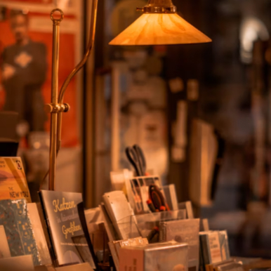 A cozy independent bookstore filled with carefully curated books, warm lighting and inviting reading spaces.