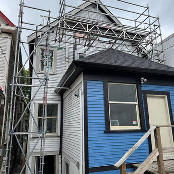 On-site view of ladder-access scaffold integrated into a residential renovation site by IBEK Scaffolding Ltd in Vancouver’s Downtown Eastside.