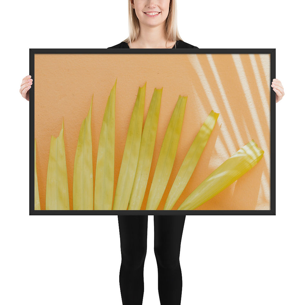 Thumbnail: Framed art print of golden-yellow palm frond on peach wall, Frameifi, framed wall art, warm-toned decor, boasting minimalist botanical photography in a black frame.