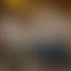 restaurant with a wood roof and white hanging lighting, blue tables and chairs, a few people at tables