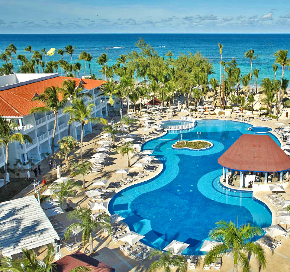 Swimming pool at bahia Pirncipe luxury Esmeralda, with the ocean in the background and three story villas