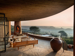 Aerial view of &Beyond Suyian Lodge nestled in Kenya’s Laikipia wilderness, surrounded by rocky outcrops and open savannah, with private plunge pools and panoramic views.