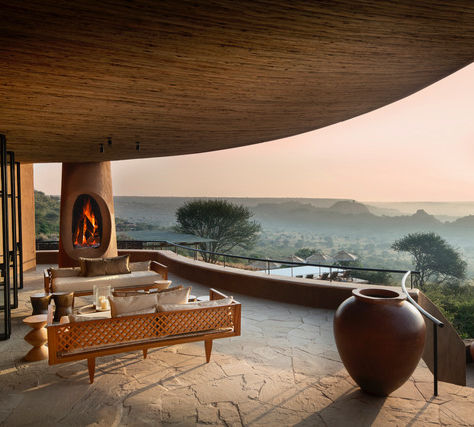 Aerial view of &Beyond Suyian Lodge nestled in Kenya’s Laikipia wilderness, surrounded by rocky outcrops and open savannah, with private plunge pools and panoramic views.