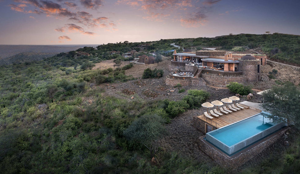 Aerial view of &Beyond Suyian Lodge nestled in Kenya’s Laikipia wilderness, surrounded by rocky outcrops and open savannah, with private plunge pools and panoramic views.