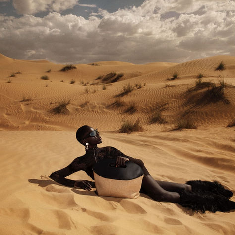 Fashion editorial photographed by Giulia Campitelli in Zanzibar, showcasing styling by Vincenzo Palatiello amid beach, palm, and safari backdrops.