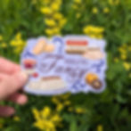 Hand holding periwinkle sticker that says "Feeling Fancy" in script font.