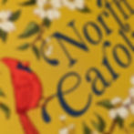 Thumbnail: Close-up of North Carolina magnet illustration showing detailed cardinal and dogwood branch