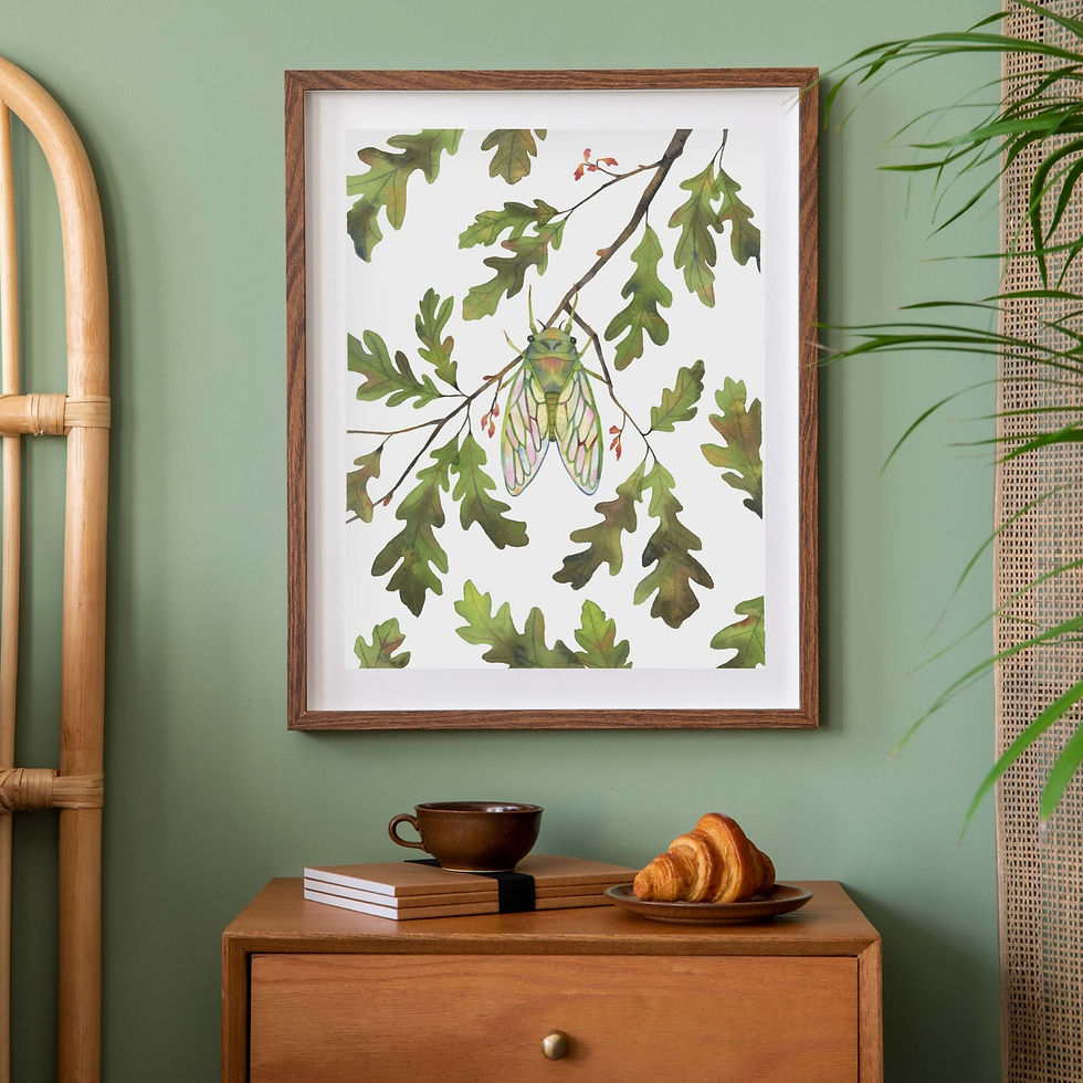 Cicada watercolor art print in wood frame on sage green wall above dresser with coffee and croissant