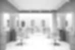 Up market modern clean hair and beauty salon with chairs facing oval mirrors