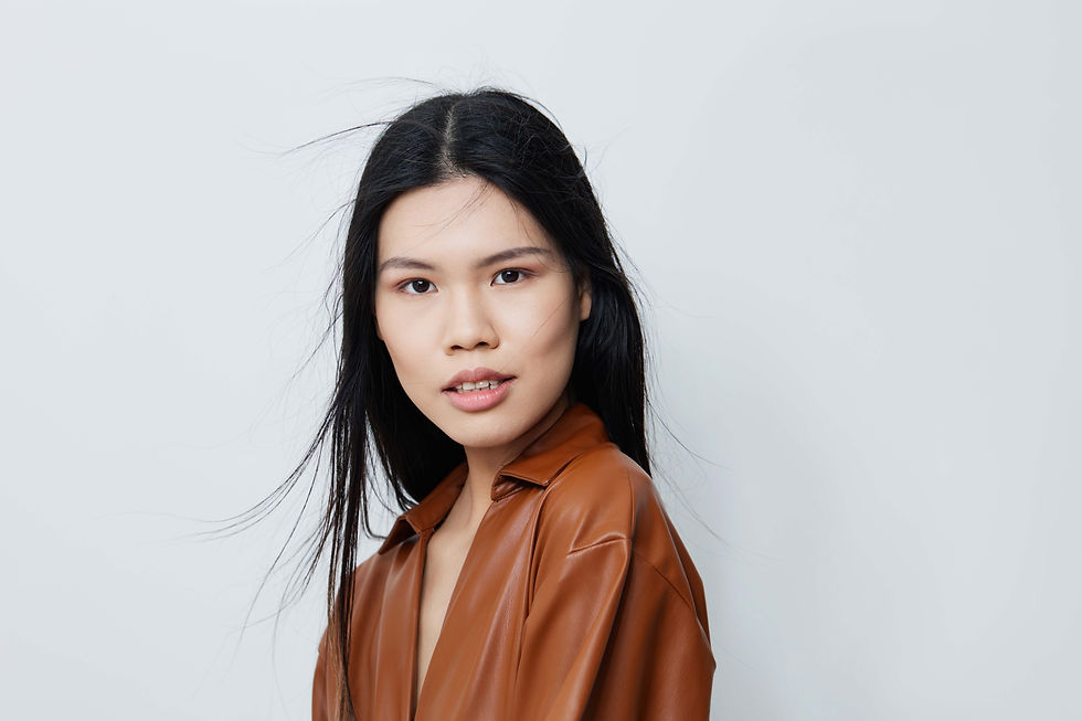 A confident young woman wearing a brown faux leather shirt, symbolizing fast fashion sophistication and modern textile production—highlighting the themes of Zara’s strategic manufacturing in Turkey.