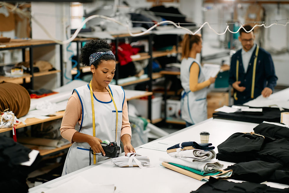 Female garment worker labeling folded fabrics in a textile factory, illustrating real-life clothing manufacturer limitations during production.