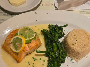 A plate with salmon, vegetables, and rice