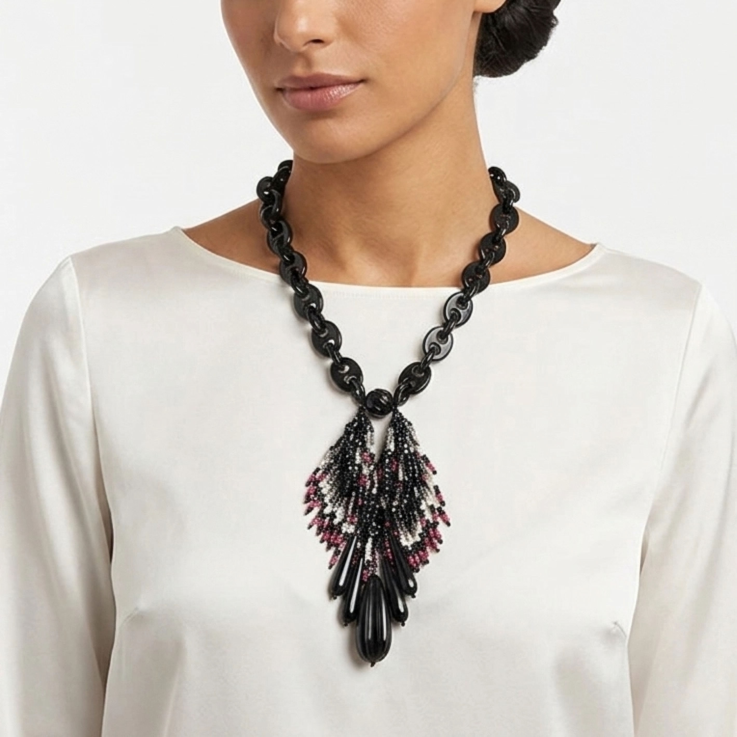 Elegant choker necklace with resin black chain and pink and black beads central pendant.