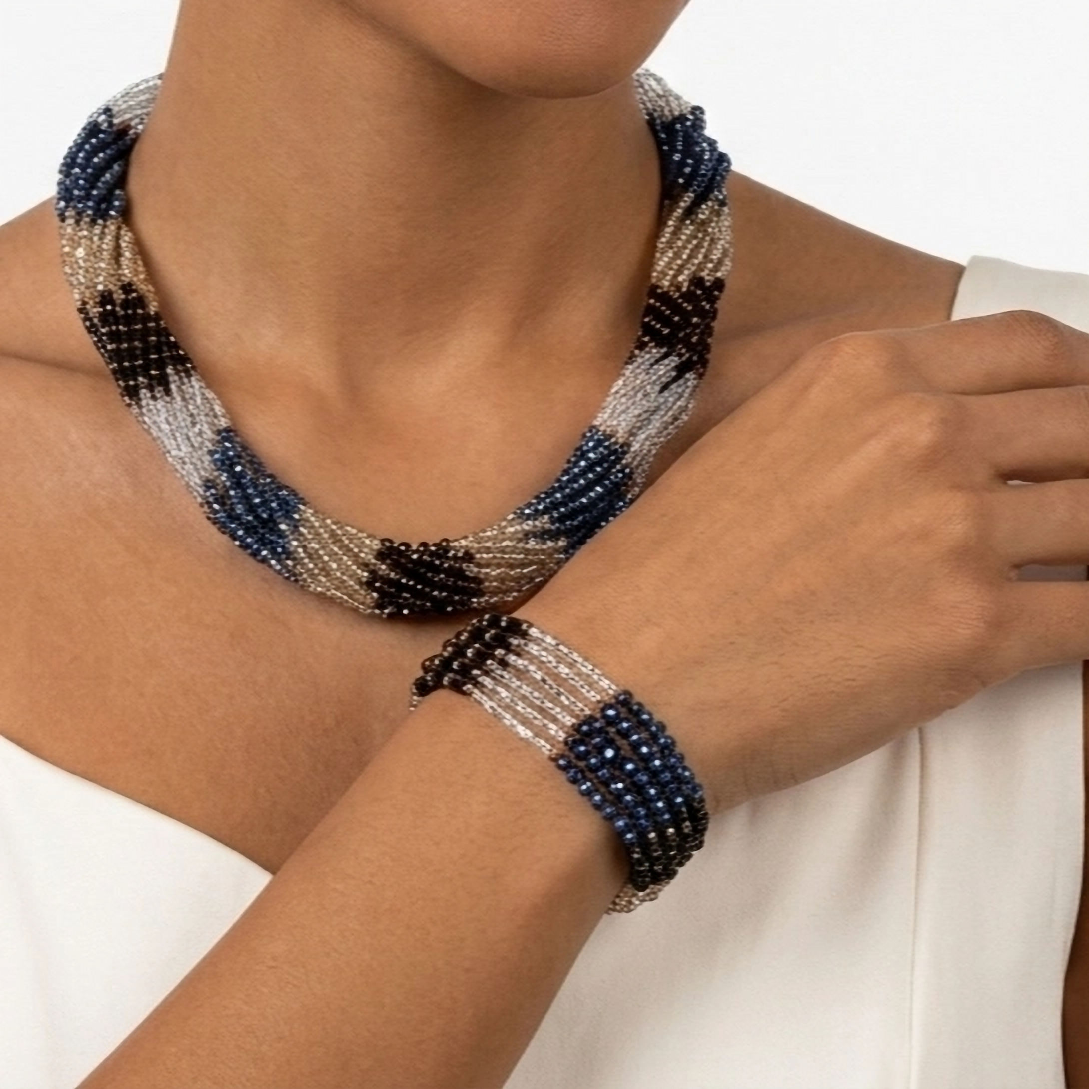 Handcrafted multi-strand bracelet with blue, bronze and black crystals on a golden frame.
