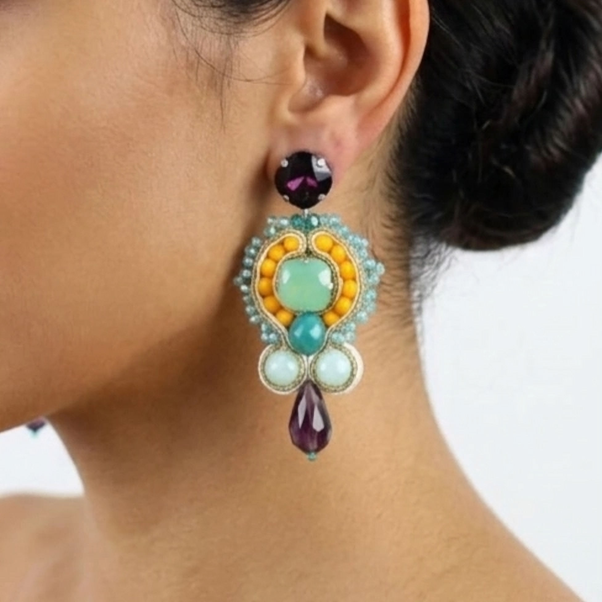 Handcrafted yellow soutache drop earrings with a central green opal stone and teardrop purple amethyst crystals.