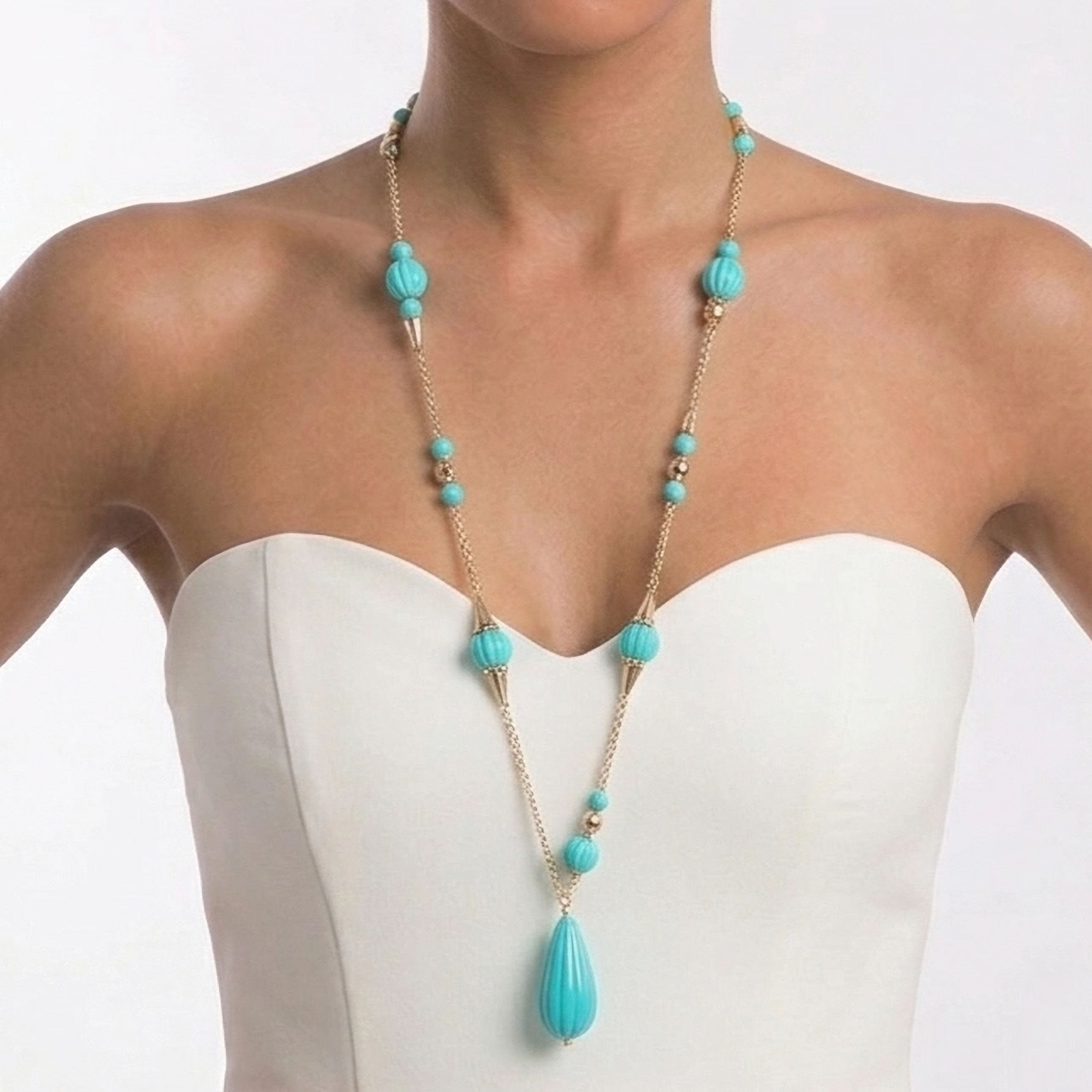Long necklace with red or turquoise resin beads, a central teardrop pendant, and a gold-plated chain.