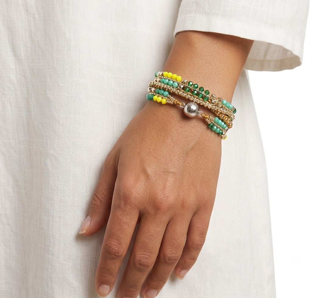 Handcrafted bracelet in shades of yellow and green, featuring faceted beads, gold-tone details, and a magnetic clasp.