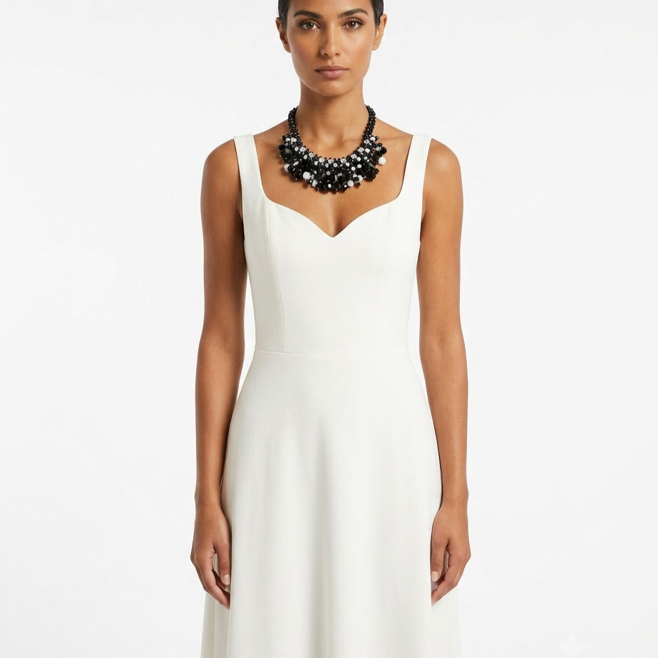 Handcrafted necklace with black pearls, faceted clear crystals, and a cascading design.
