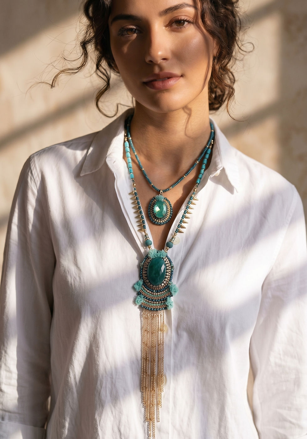 Medium petrol blue necklace with double strand and pendant embroidered with Swarovski crystals.