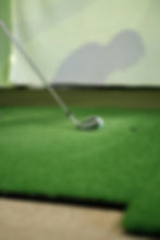 Golf Club Teeing up for a hit. for background showing a shadow of a person being casted onto the simulator screen