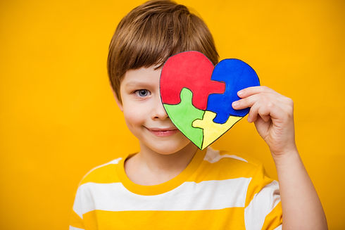 Kid boy hands holding puzzle heart, child mental health concept, world autism awareness da