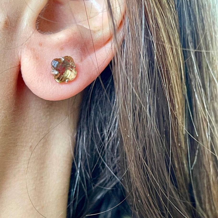 Zultanite Faceted Earring worn on the ear, showing the warm faceted gemstone sparkle.