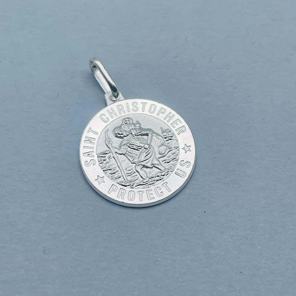 Saint Christopher Protect Us silver pendant displayed on a pale blue background, showing detailed engraving.