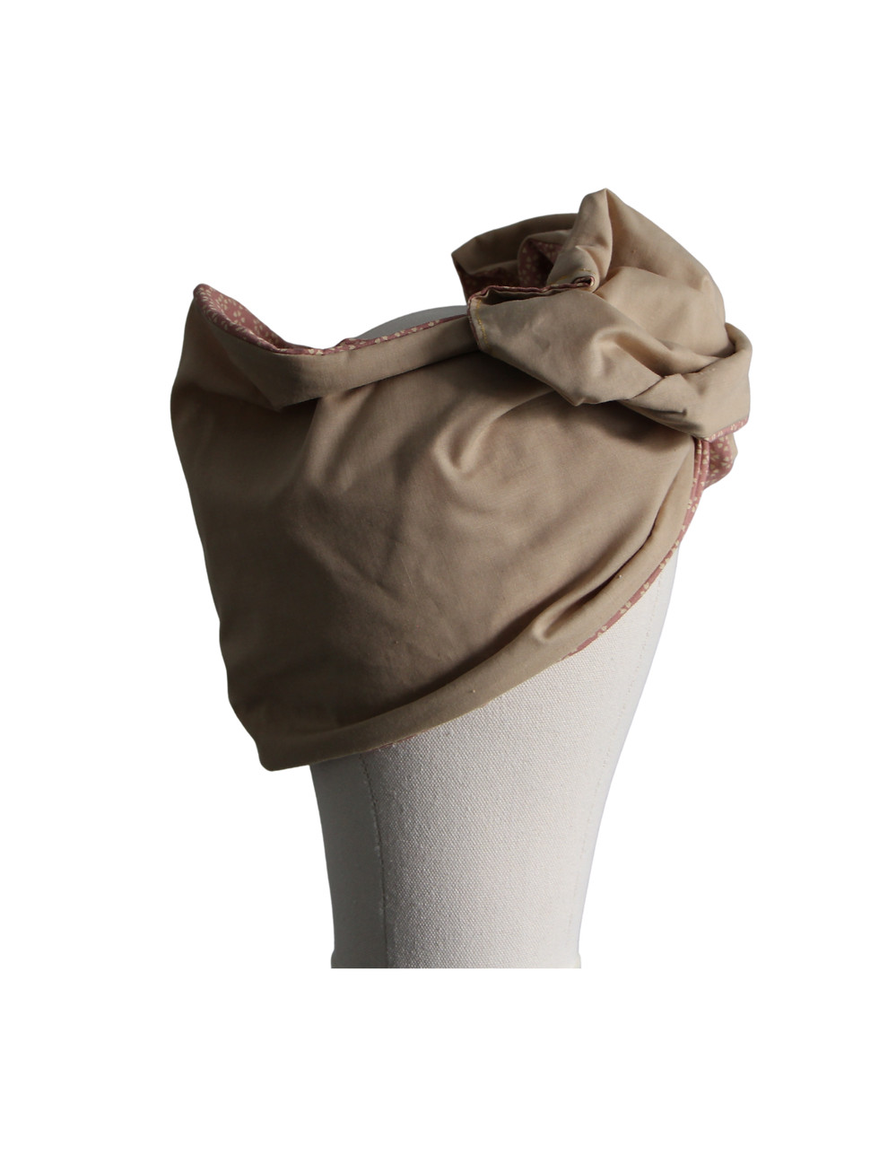 Thumbnail: Beige head covering on a white stand against a black background.