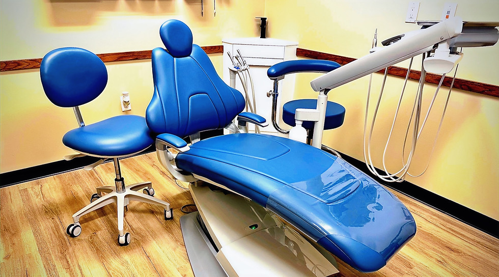 Blue dental chair in a bright, clean office environment for patient treatment.