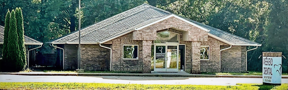 Exterior shot of Spring Dental building on a sunny day with trees in background.