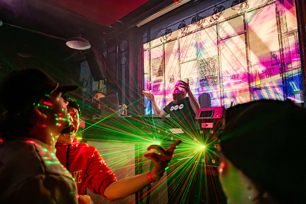 People dancing with green light effects throughout the room