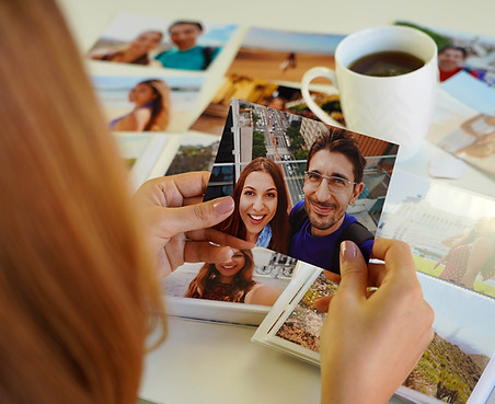 A mom woman looking at a romantic image-prints-with-her DIY poster Vision Board
