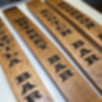 Bar signs made from bourbon barrels
