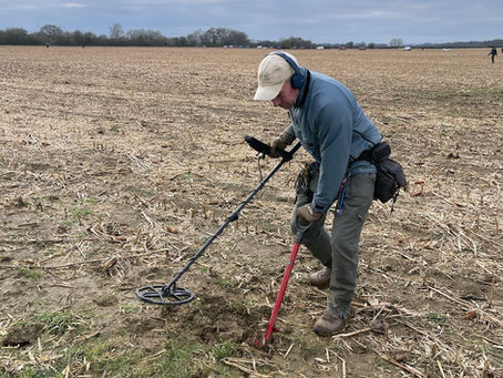 man detecting in a field