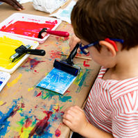 Child painting a picture at the La Jolla Art & Wine Festival