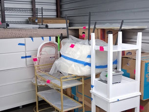 Eye-level view of a packed dorm room with labeled moving boxes ready for storage
