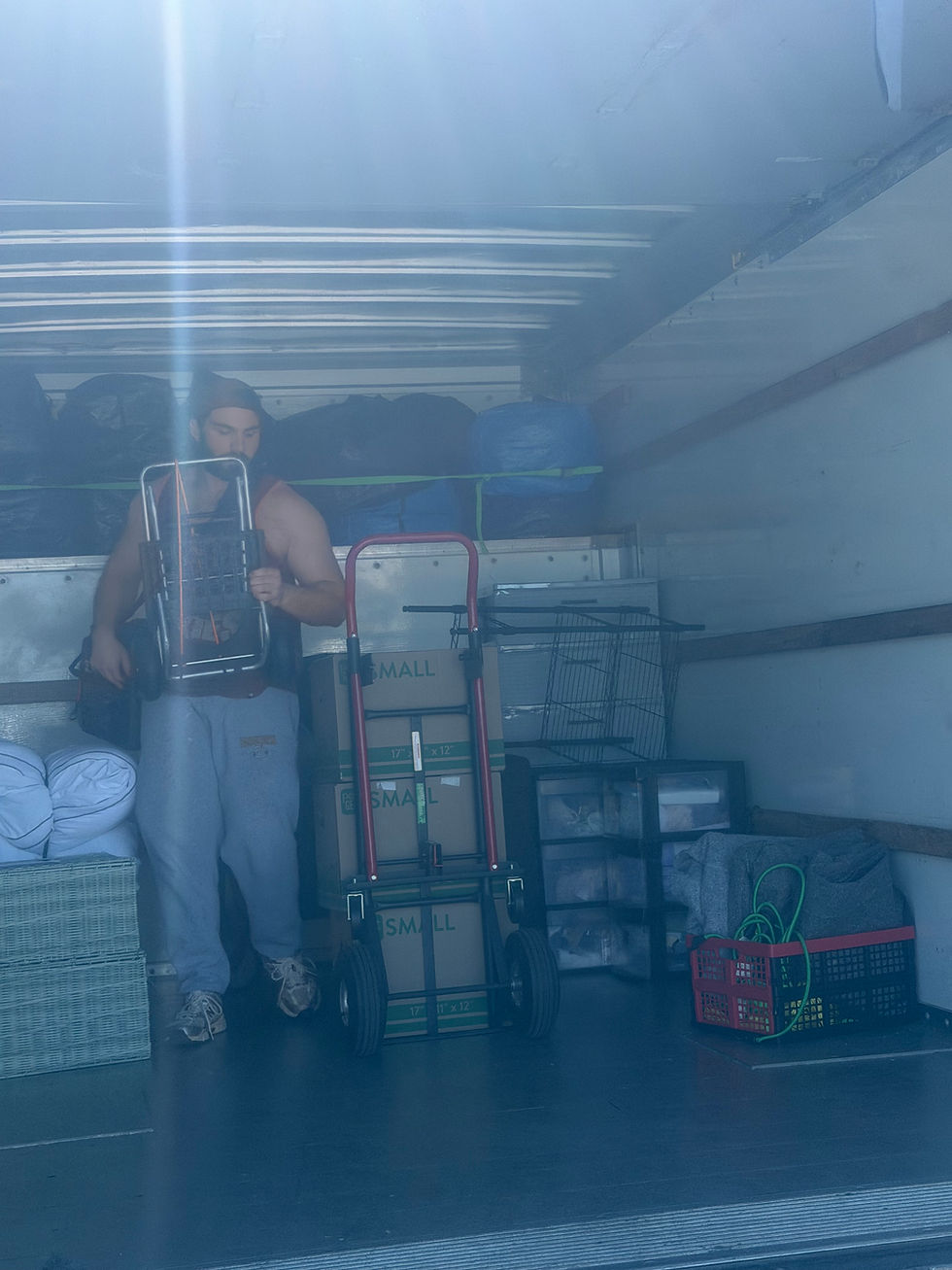 Eye-level view of a moving truck parked outside a college dorm building