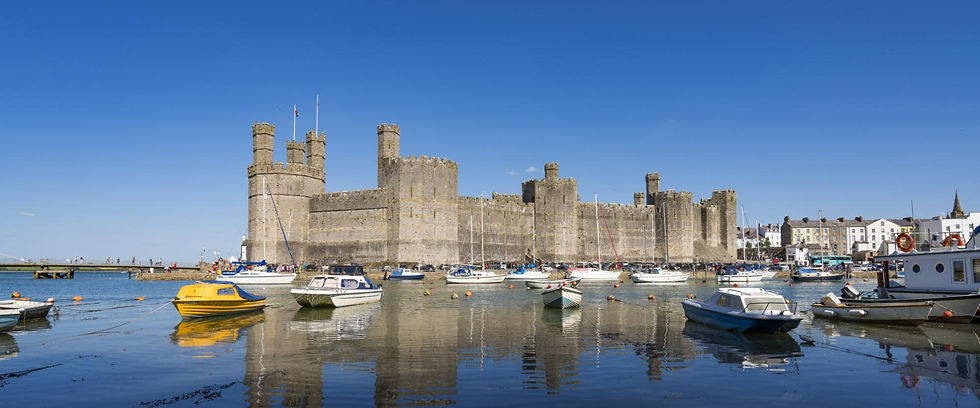 Wide angle view of Caernarfon Castle's majestic towers