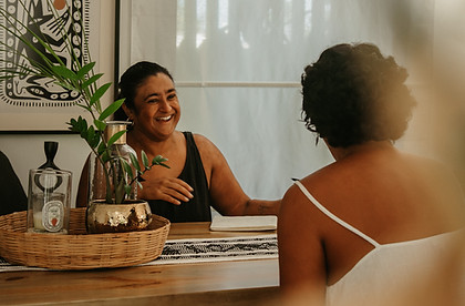 Sonal laughing sitting across the table from a client