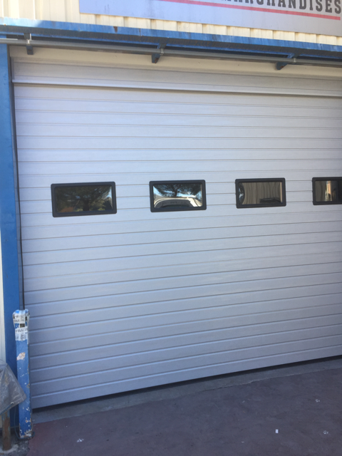 Porte de garage sectionnelle avec fenêtres intégrées – installation sur mesure POL GLASS