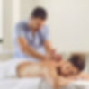 Therapist giving back massage