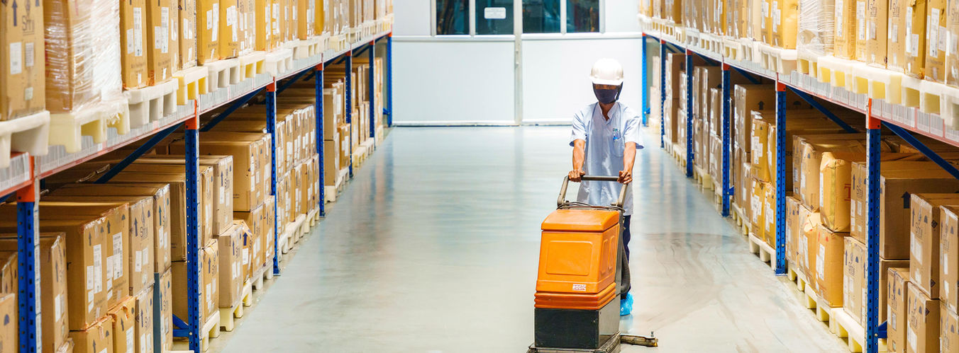 Person cleaning the warehouse floor