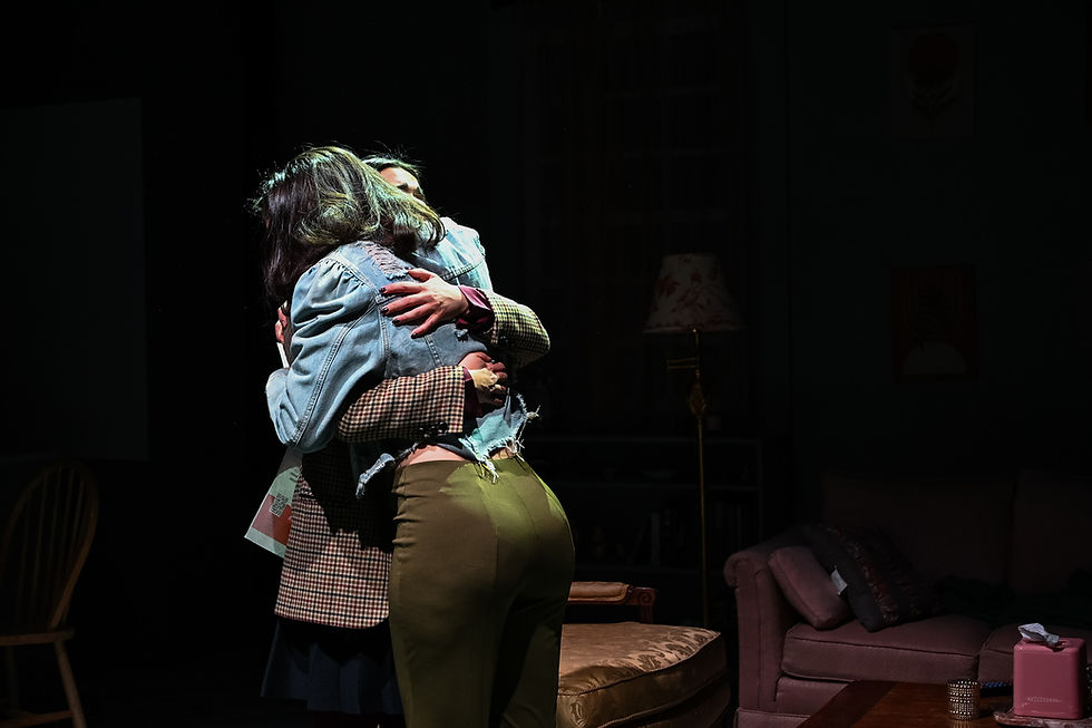 Jenna Barricklo as Becca and Shay Shalem as Nili embrace onstage in ANEMONE
